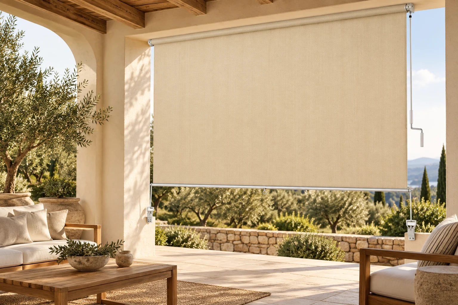 Beige outdoor crank roller shade installed on a covered patio